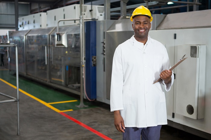 Portrait of smiling male worker holding clipboard in warehouse